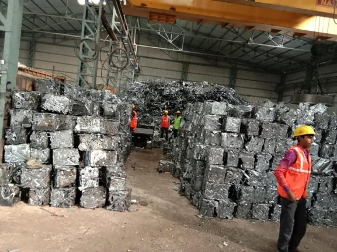 Electric magnetic crane loading processed scrap at a Yashu Iron facility
